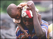 Congolese man carries young child